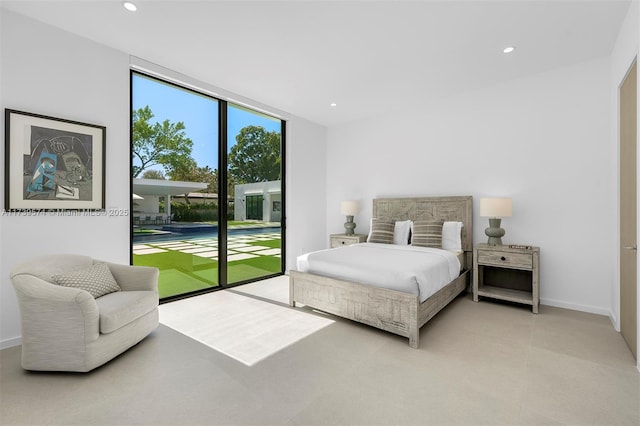 bedroom with floor to ceiling windows and access to outside