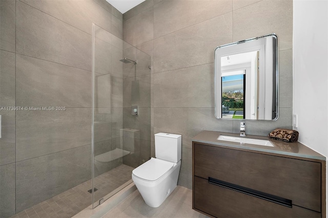 bathroom featuring tile walls, vanity, toilet, and walk in shower