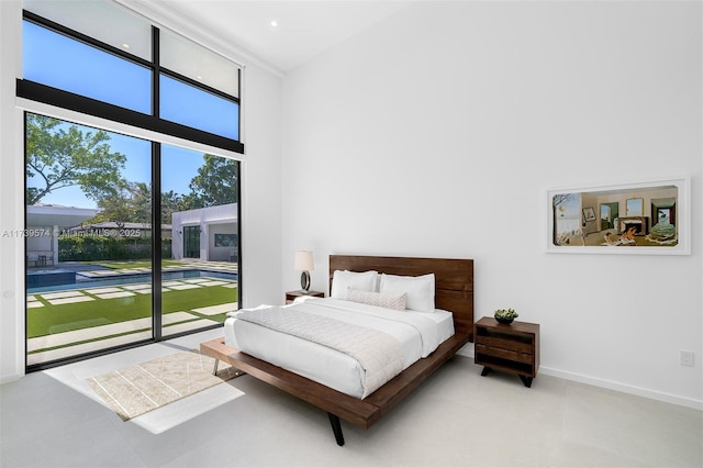 bedroom with access to outside and a high ceiling