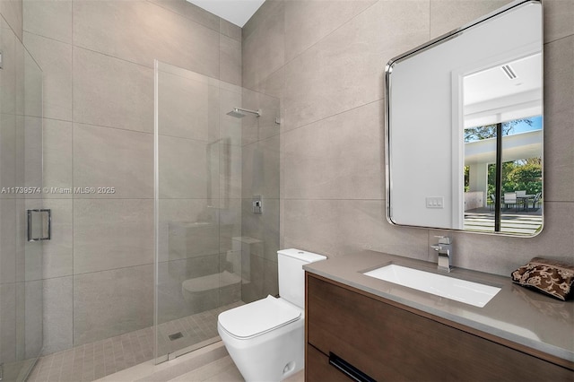 bathroom with an enclosed shower, vanity, toilet, and tile walls