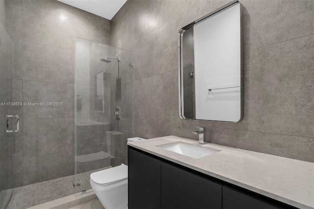 bathroom featuring toilet, an enclosed shower, tile walls, vanity, and decorative backsplash