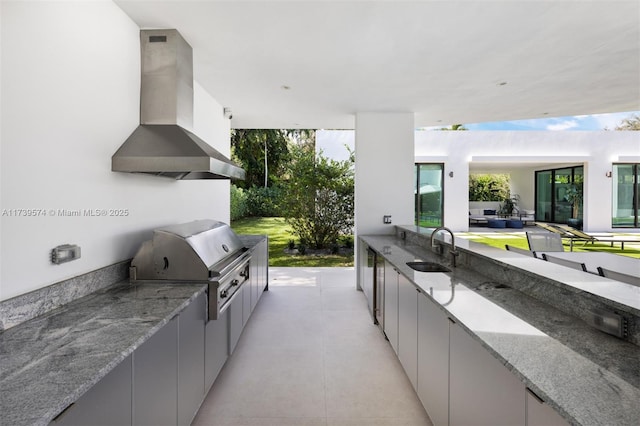 view of patio with sink, a grill, and exterior kitchen