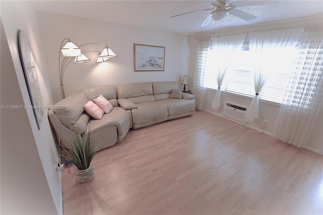 living room with wood-type flooring and ceiling fan