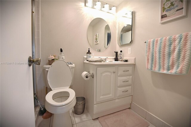 bathroom with vanity, tile patterned flooring, and toilet