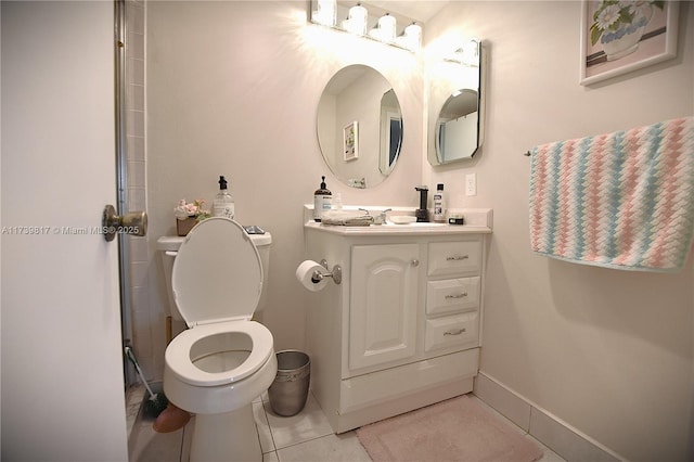 bathroom featuring vanity, tile patterned flooring, and toilet