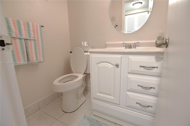 bathroom with vanity, tile patterned floors, and toilet