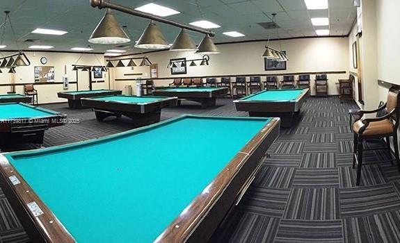 rec room featuring dark carpet, pool table, and a paneled ceiling