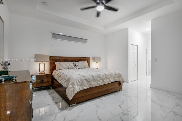 bedroom with a raised ceiling and ceiling fan