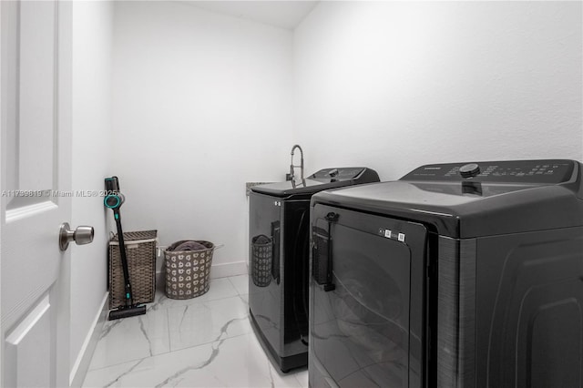 laundry area featuring washing machine and clothes dryer