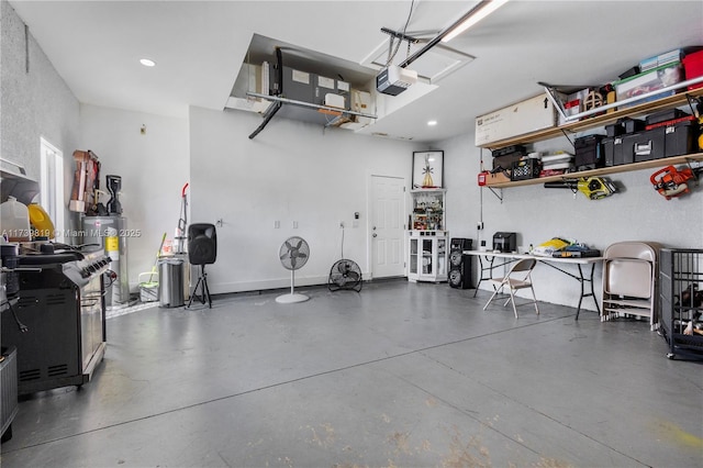 garage featuring a garage door opener and electric water heater