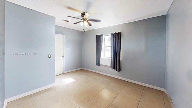 unfurnished room featuring light tile patterned floors, baseboards, and a ceiling fan