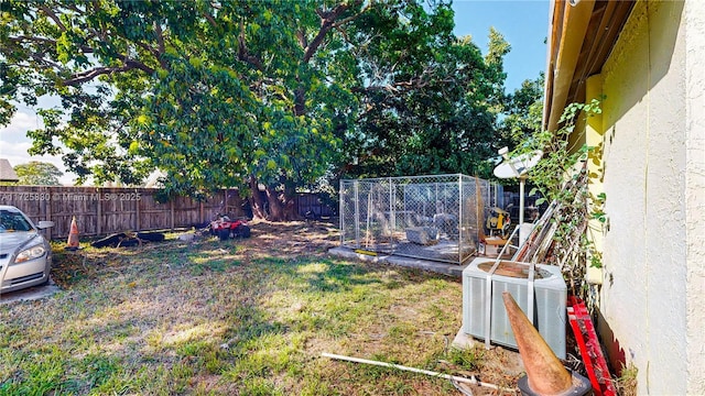 view of yard featuring a fenced backyard and central AC