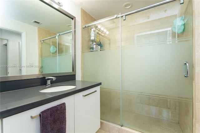 bathroom with vanity and walk in shower