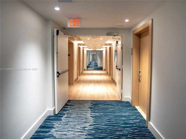 corridor with wood-type flooring