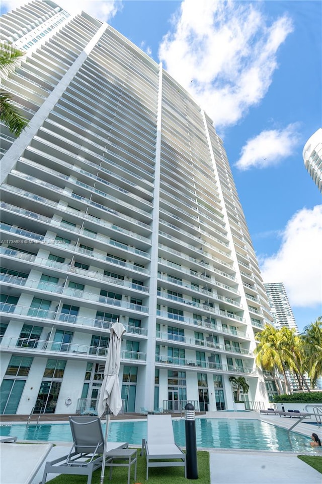 view of building exterior with a community pool