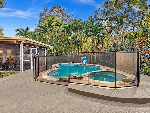 view of pool featuring a patio area, a fenced backyard, a fenced in pool, and an in ground hot tub