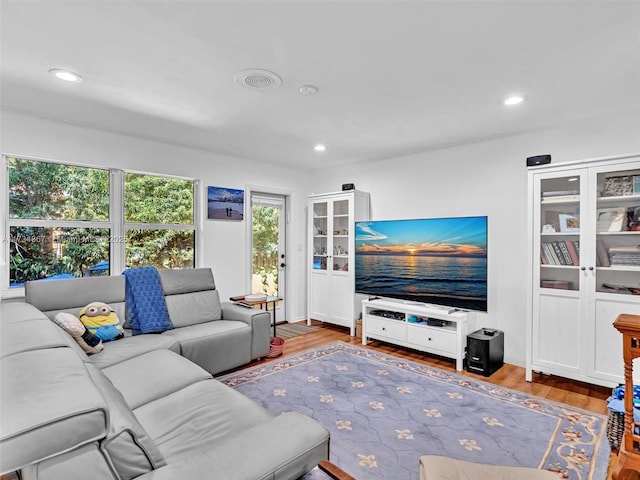 living room with recessed lighting and wood finished floors