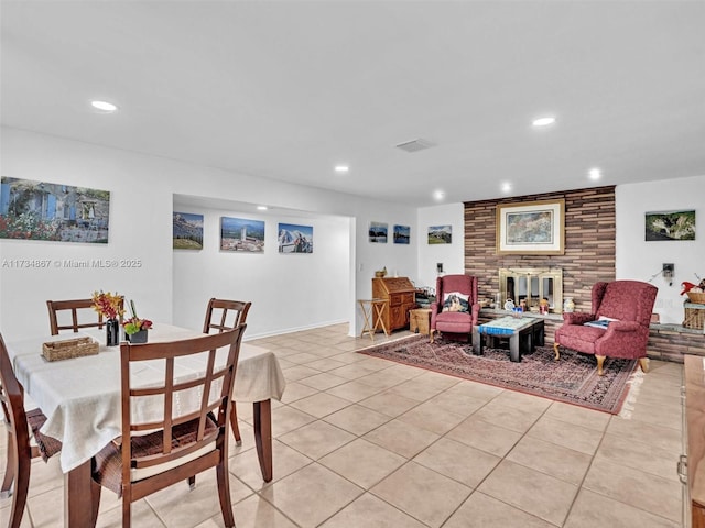 dining space featuring recessed lighting, visible vents, a fireplace, and light tile patterned floors