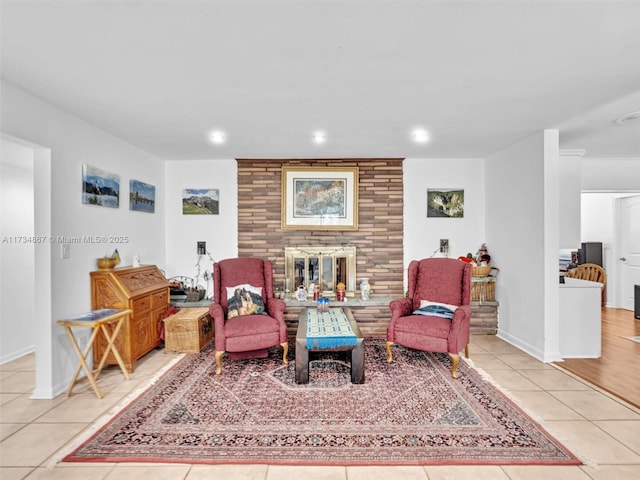 living area with recessed lighting, a brick fireplace, baseboards, and tile patterned floors