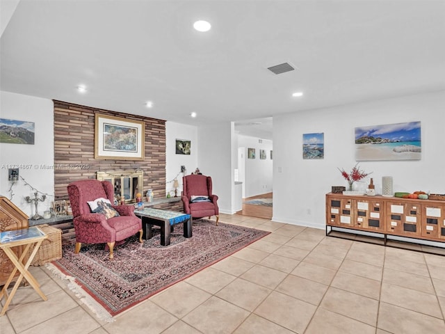 living area with a fireplace, light tile patterned floors, recessed lighting, visible vents, and baseboards