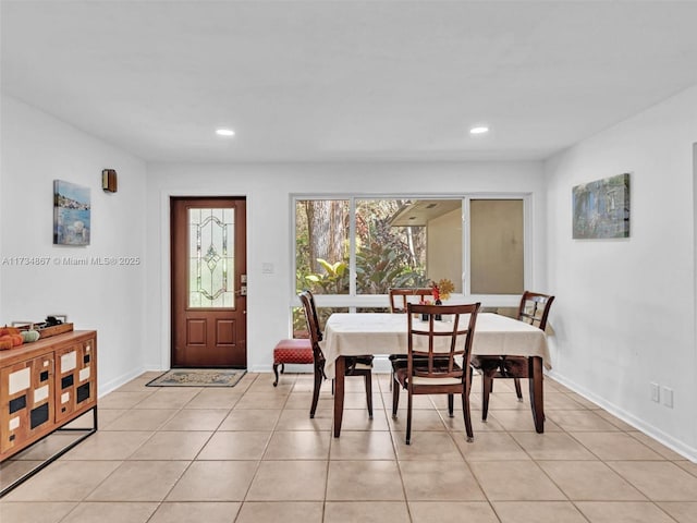 dining room with light tile patterned floors, baseboards, and recessed lighting