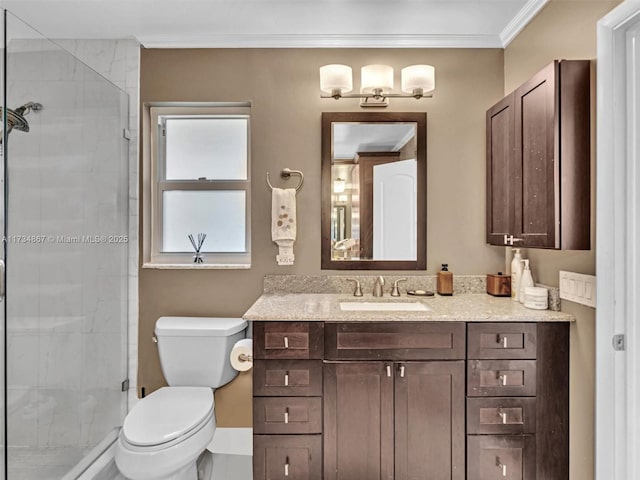 full bath with toilet, a stall shower, crown molding, and vanity