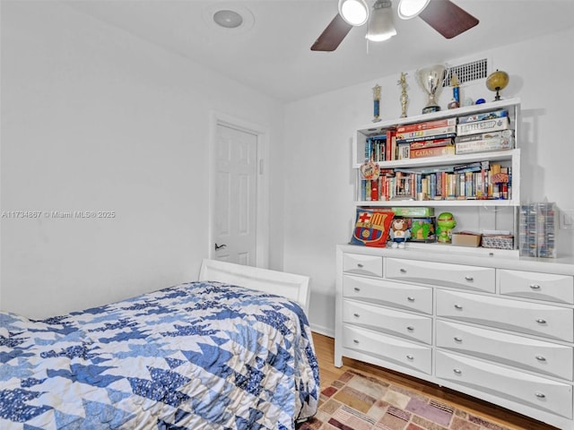 bedroom with light wood-type flooring and a ceiling fan