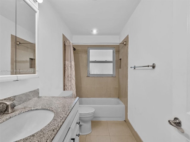 bathroom with toilet, vanity, baseboards, tile patterned floors, and shower / bath combo