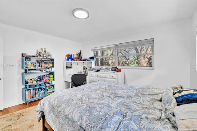 bedroom with wood finished floors