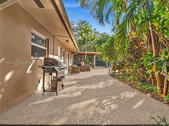 view of patio / terrace featuring a sunroom and area for grilling