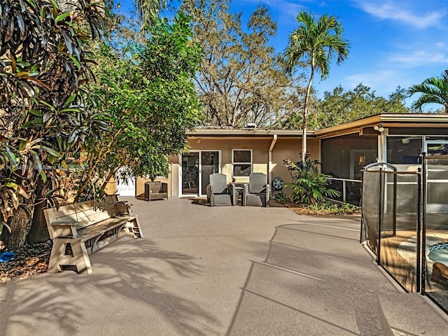 view of patio with a sunroom