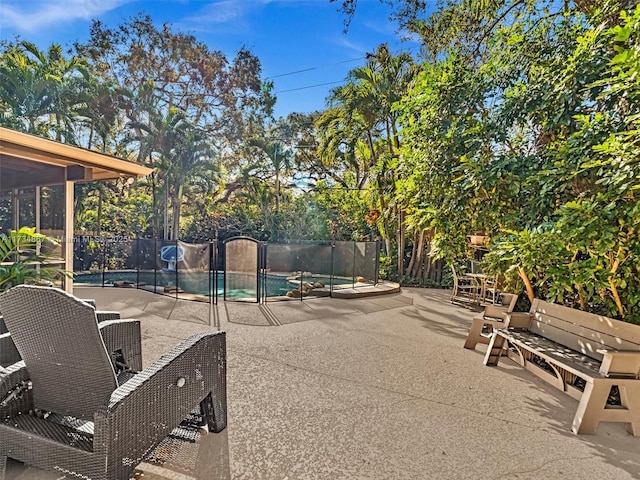 surrounding community with a swimming pool, fence, and a patio