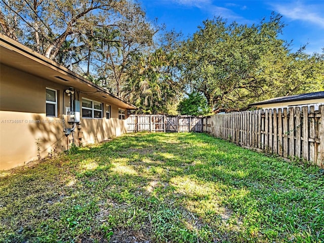 view of yard with a fenced backyard