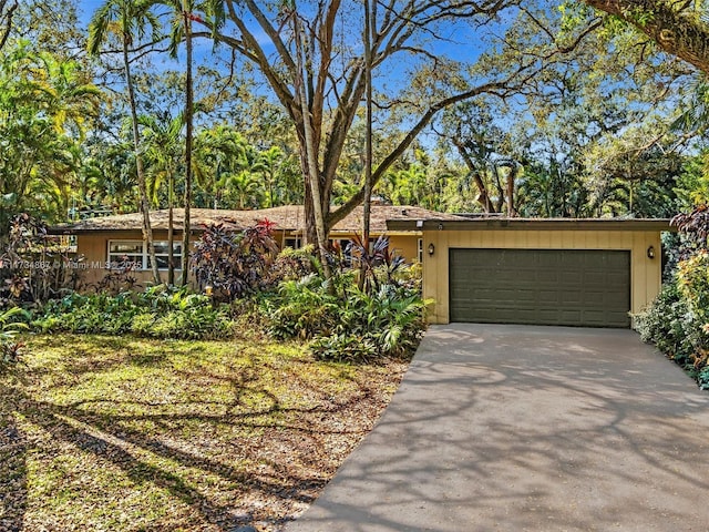 view of front facade featuring concrete driveway and an attached garage