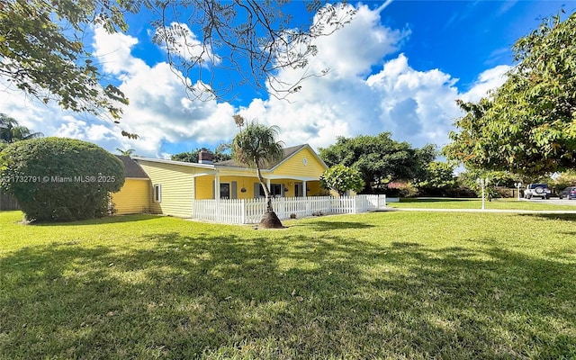 ranch-style house with a fenced front yard and a front lawn