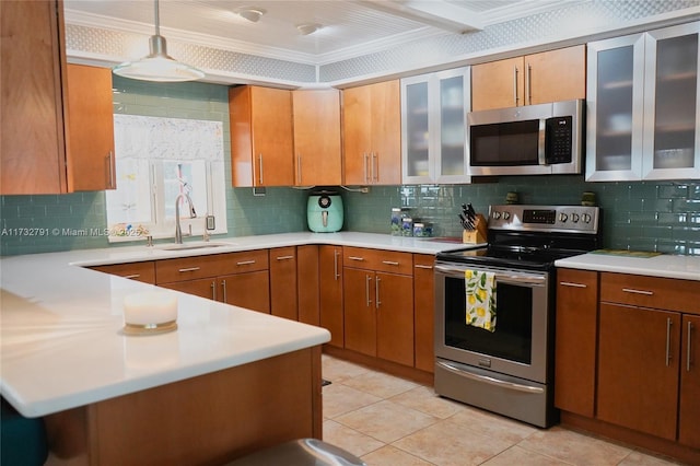 kitchen with pendant lighting, sink, crown molding, stainless steel appliances, and decorative backsplash