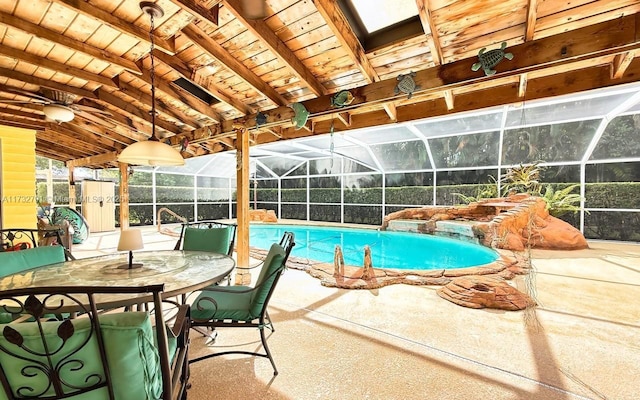 view of swimming pool featuring glass enclosure and a patio area