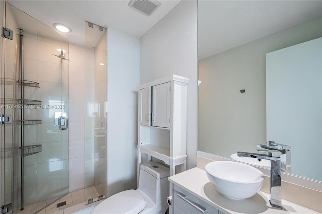 bathroom with toilet, a stall shower, visible vents, and vanity