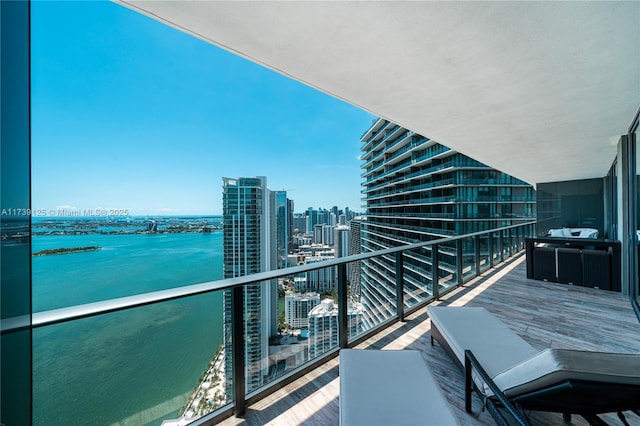 balcony featuring a view of city and a water view