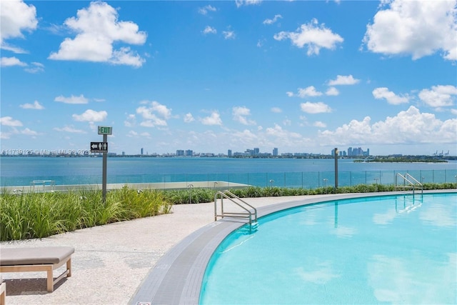 view of swimming pool with a water view