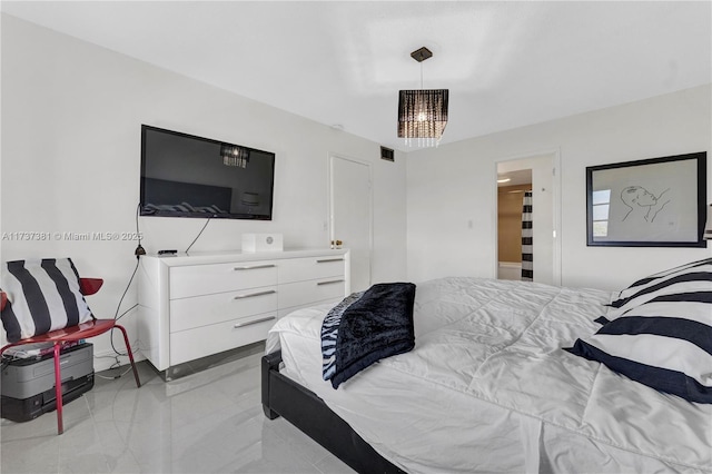 bedroom featuring a notable chandelier