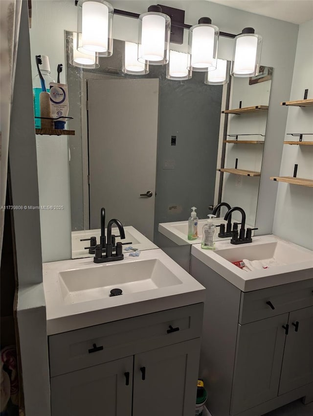 bathroom featuring two vanities and a sink