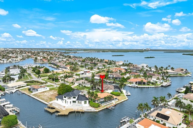 drone / aerial view featuring a water view and a residential view