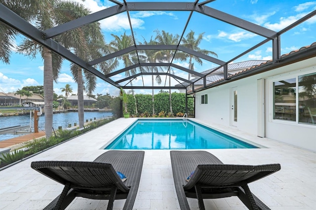 outdoor pool with a patio, a boat dock, boat lift, a water view, and a lanai