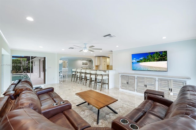 living room featuring arched walkways, baseboards, visible vents, and recessed lighting