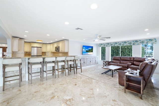 living area featuring recessed lighting, marble finish floor, visible vents, and ceiling fan