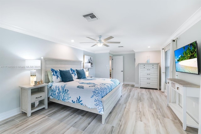 bedroom featuring light wood finished floors, baseboards, visible vents, and ornamental molding