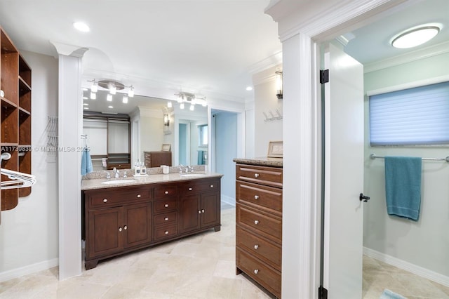 full bath featuring double vanity, ornamental molding, and a sink