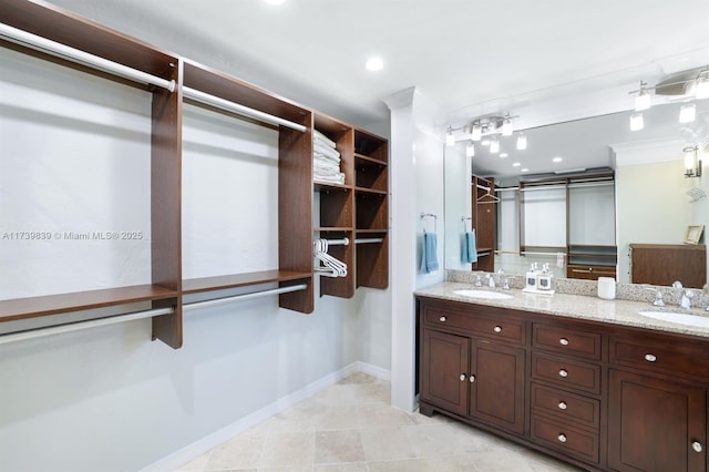 spacious closet featuring light tile patterned flooring and a sink