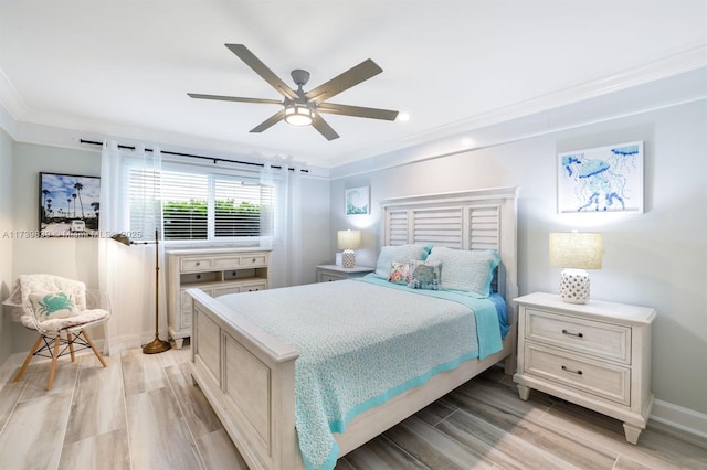 bedroom with a ceiling fan, crown molding, light wood-style flooring, and baseboards